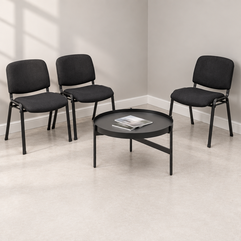 Three visitor chairs and a round coffee table in a clean showroom waiting area